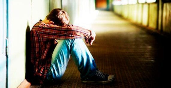 Depressed young man contemplating suicide Canada mishandling mental illness crisis
