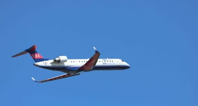 white and red air plane in flight Bombardier the poster child of pork-barrel cronyism