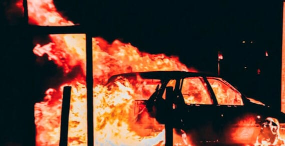 Burning car at racism protest Poverty often at the root of racism, hate