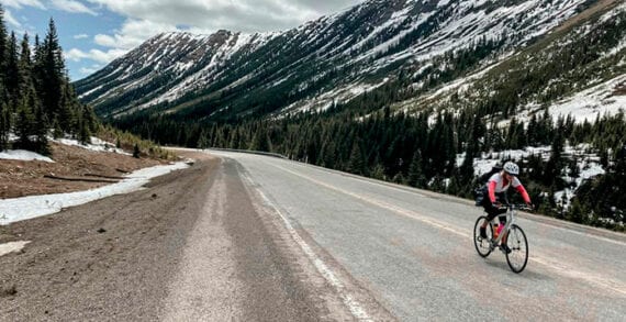 Lisa Monforton, ConnecTour group member, rides the road the Highwood Pass, at 2,206 metres, the highest elevation paved pass in Canada COVID panic? Keep calm and carry on with bike tour planning