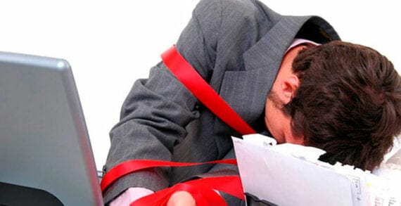 Businessman wrapped in red tape High taxes, red tape keeping entrepreneurs out of New Brunswick