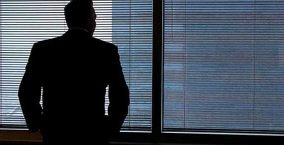 Businessman staring out of window Why many leaders are lonely and what to do about it